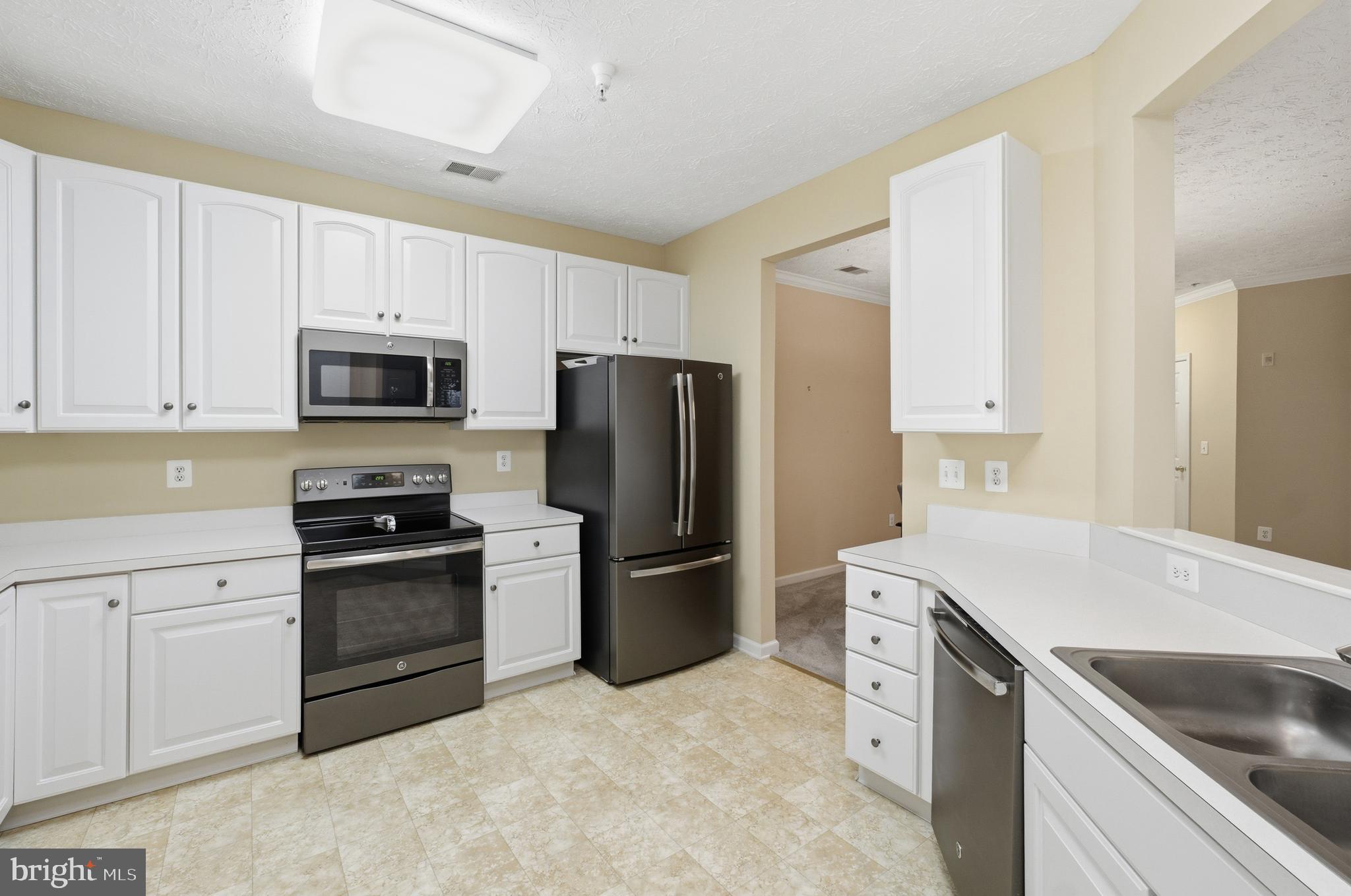 9613 Haven Farm Road, Unit 9613G Perry Hall, MD 21128 - Photo 19 of 37 a kitchen with a sink stove and refrigerator