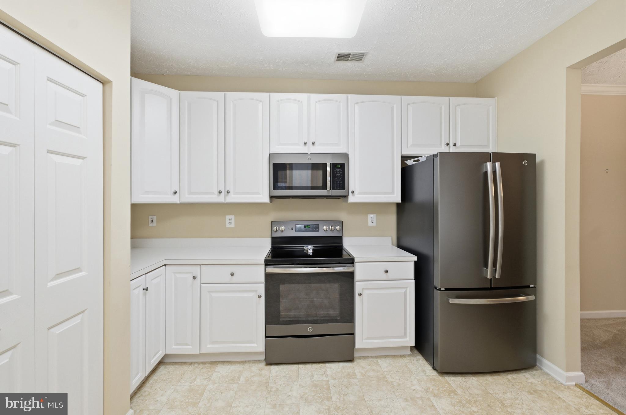 9613 Haven Farm Road, Unit 9613G Perry Hall, MD 21128 - Photo 20 of 37 a kitchen with a refrigerator sink and microwave
