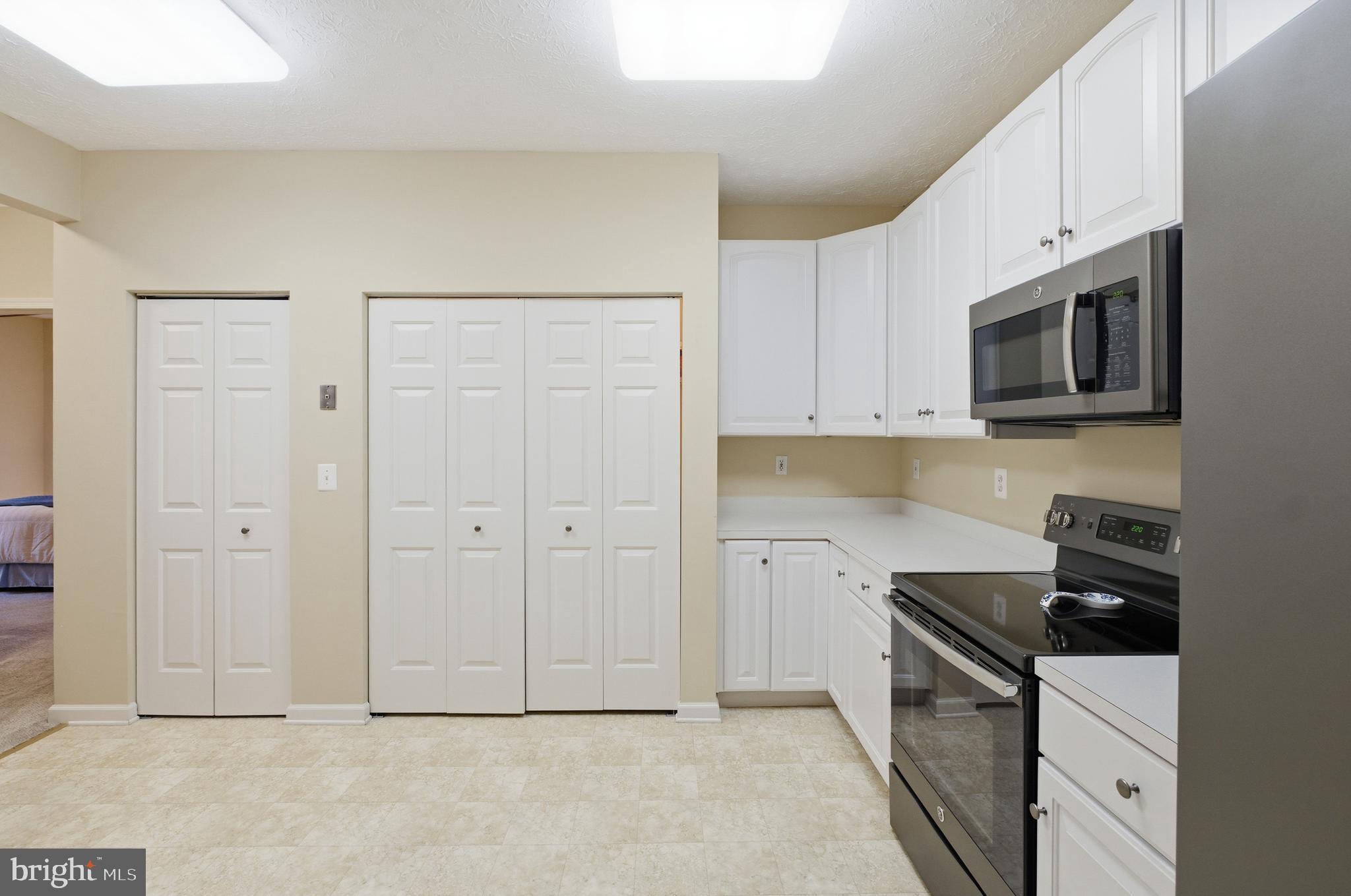 9613 Haven Farm Road, Unit 9613G Perry Hall, MD 21128 - Photo 21 of 37 a kitchen with stainless steel appliances granite countertop a stove a sink and a refrigerator