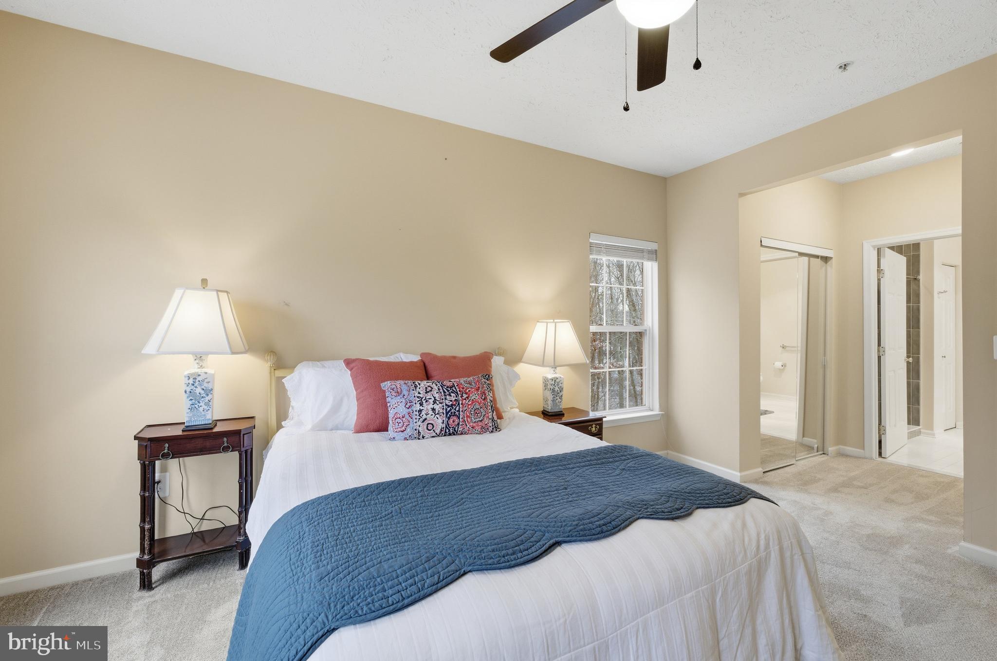 9613 Haven Farm Road, Unit 9613G Perry Hall, MD 21128 - Photo 23 of 37 a bedroom with a bed and a lamp