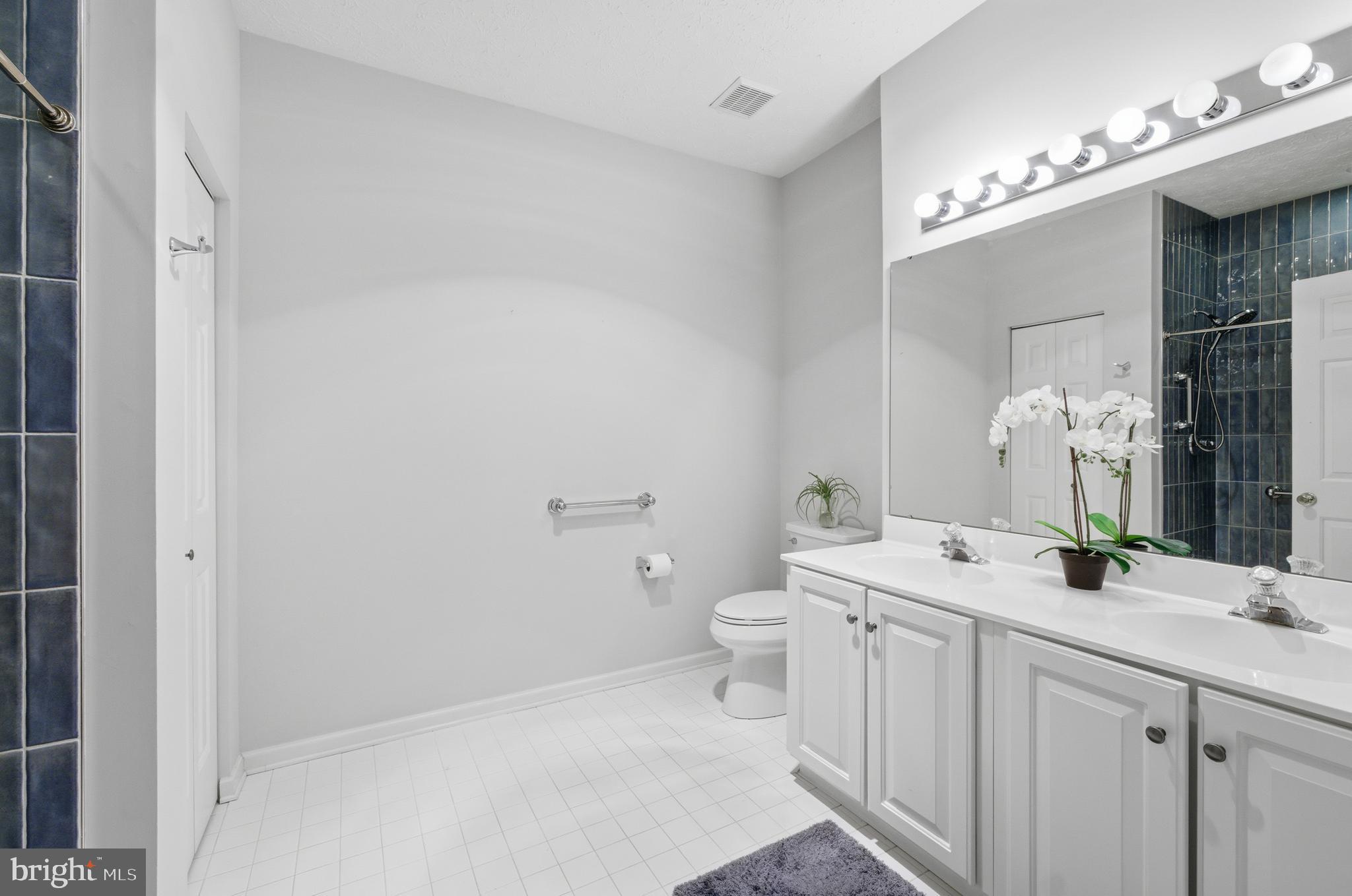 9613 Haven Farm Road, Unit 9613G Perry Hall, MD 21128 - Photo 24 of 37 a bathroom with a sink a toilet and mirror