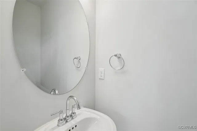 a bathroom with a sink and mirror