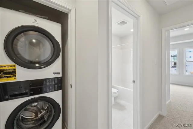 a view of a hallway with washer and dryer