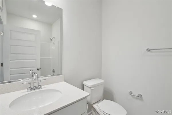 a bathroom with a sink a toilet and mirror