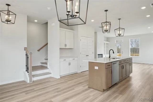 a kitchen with stainless steel appliances a stove refrigerator and cabinets