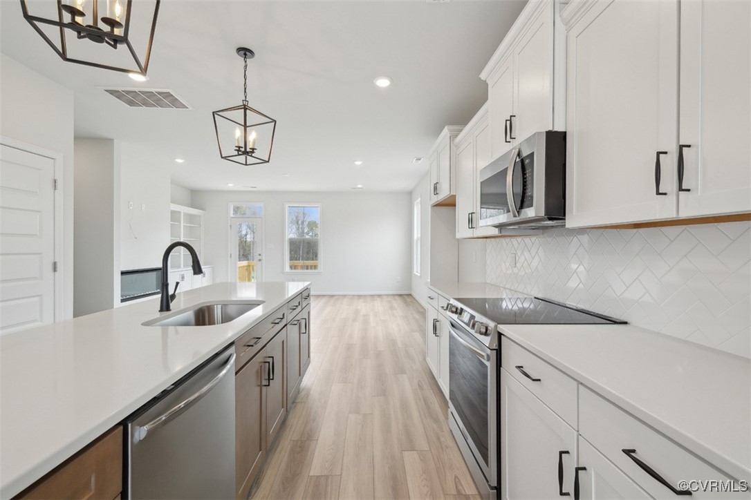 200 That Way Midlothian, VA 23114 - Photo 4 of 35 a kitchen with stainless steel appliances granite countertop a sink dishwasher a stove and a microwave oven with cabinets