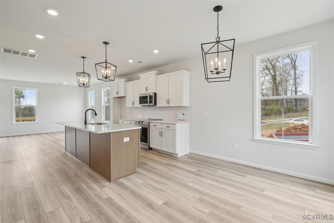 200 That Way Midlothian, VA 23114 - Photo 5 of 35 a large kitchen with stainless steel appliances granite countertop a stove a sink dishwasher and a large refrigerator with wooden floor