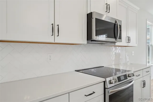 a kitchen with a stove and a microwave
