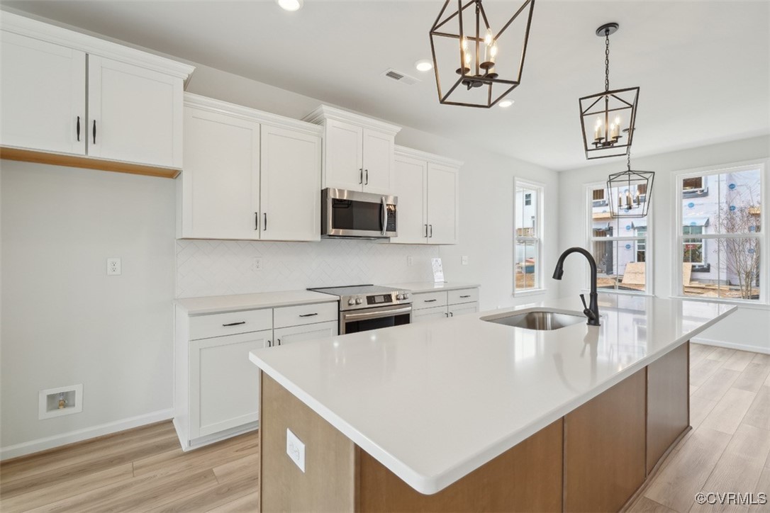200 That Way Midlothian, VA 23114 - Photo 9 of 35 a kitchen with stainless steel appliances granite countertop a stove a sink dishwasher and a microwave with wooden floor