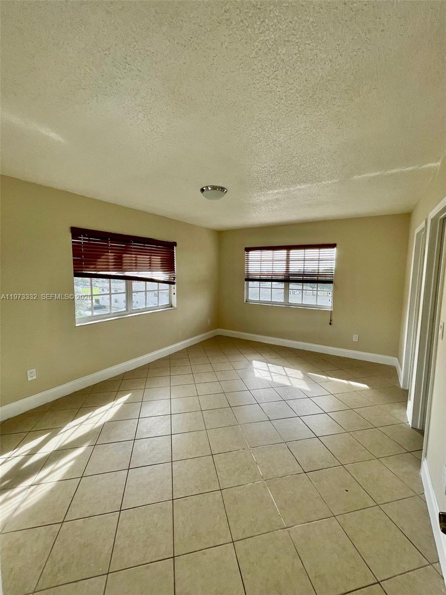1035 West 77th Street, Unit 412 Hialeah, FL 33014 - Photo 11 of 20 a view of an empty room and window