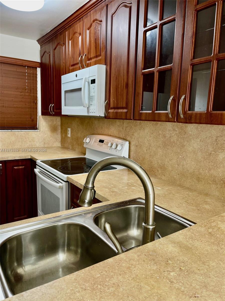 1035 West 77th Street, Unit 412 Hialeah, FL 33014 - Photo 15 of 20 a close view of utility and kitchen appliances
