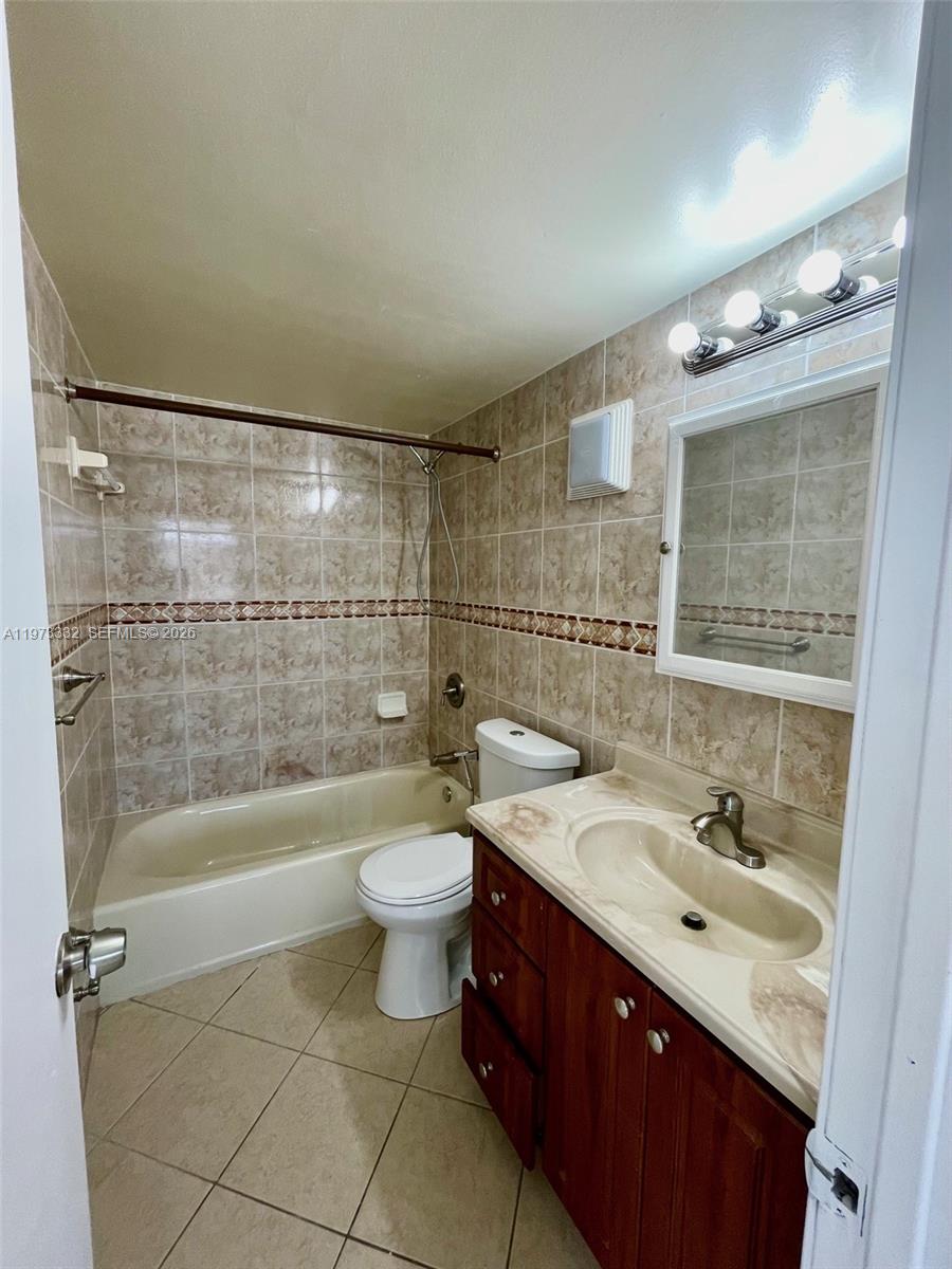 1035 West 77th Street, Unit 412 Hialeah, FL 33014 - Photo 18 of 20 a bathroom with a sink a toilet and shower