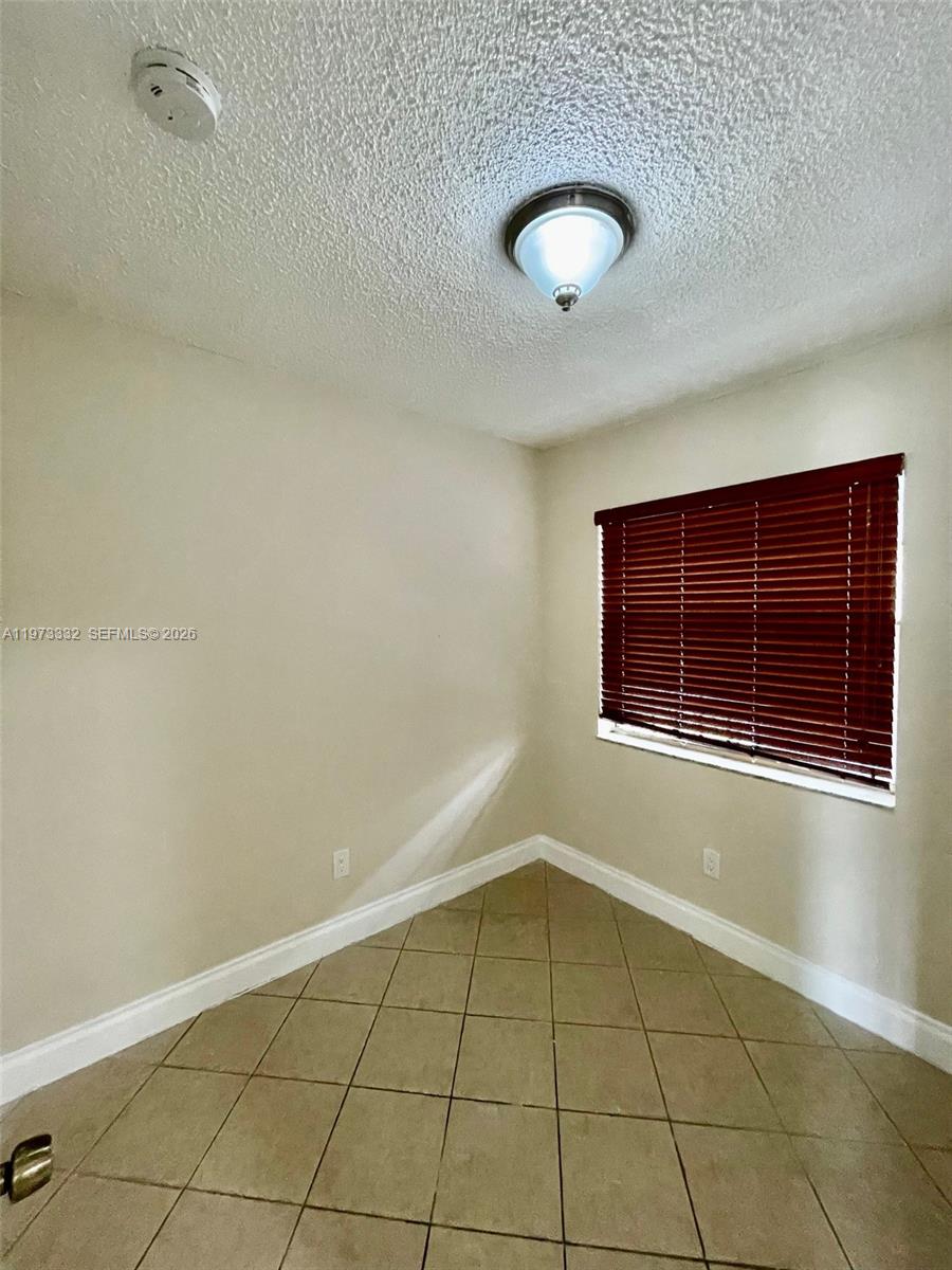 1035 West 77th Street, Unit 412 Hialeah, FL 33014 - Photo 9 of 20 a view of an empty room with a window