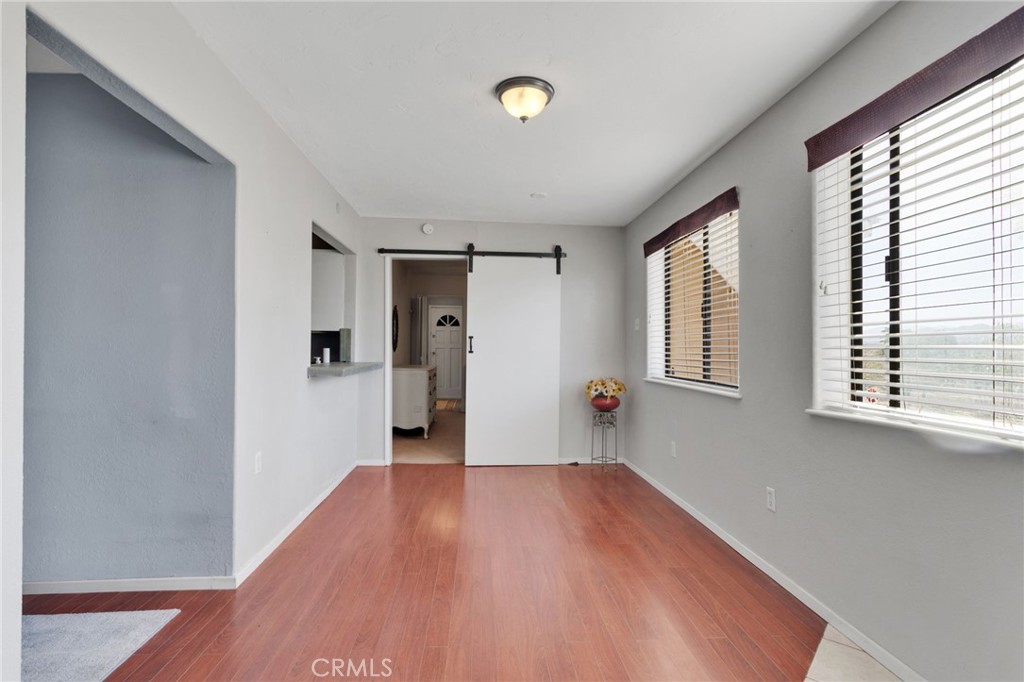38744 East End Road Lucerne Valley, CA 92356 - Photo 13 of 46 a view of an empty room with wooden floor and a window