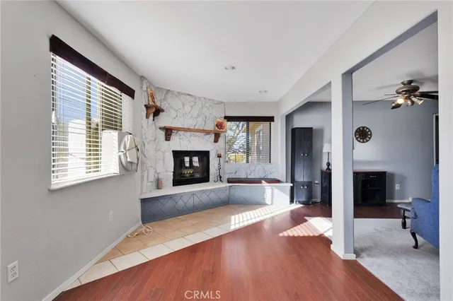 a view of an empty room with window and fire place