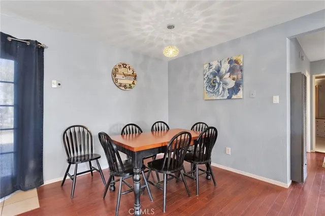 a view of a dining room with furniture and a window