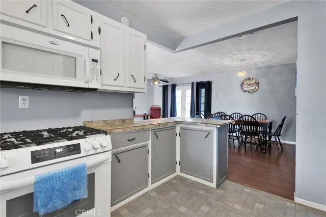 a kitchen with cabinets and stove top oven