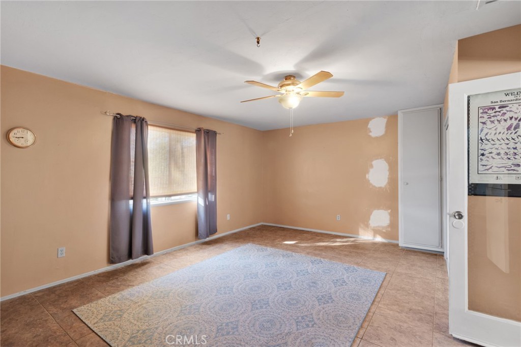 38744 East End Road Lucerne Valley, CA 92356 - Photo 33 of 46 an empty room with chandelier fan and windows