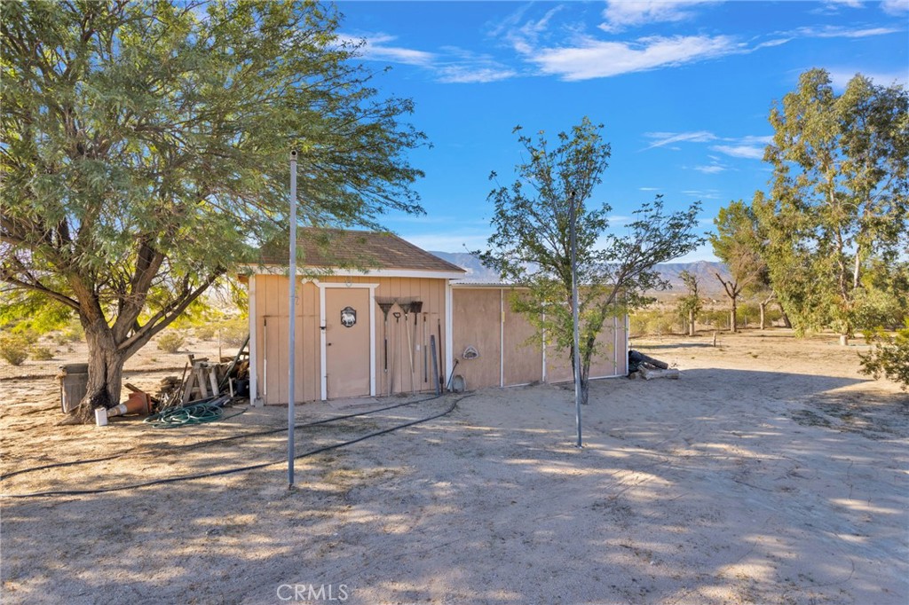 38744 East End Road Lucerne Valley, CA 92356 - Photo 7 of 46 a view of a house with a tree in front of it