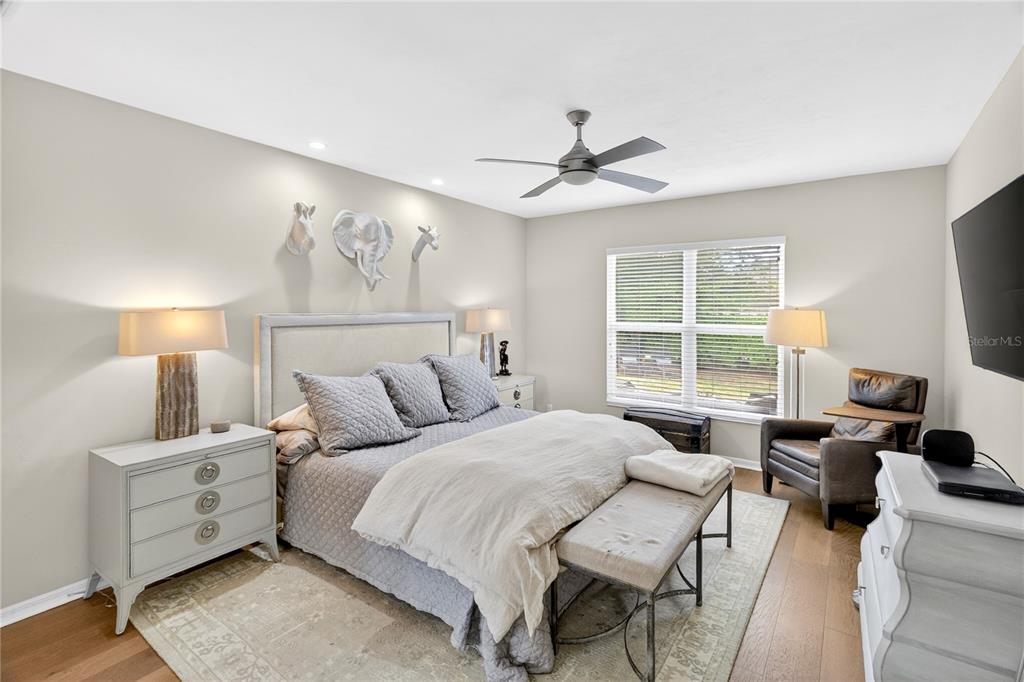 3363 Southwest 115th Terrace Gainesville, FL 32608 - Photo 13 of 43 a bedroom with a bed a couch and a flat screen tv