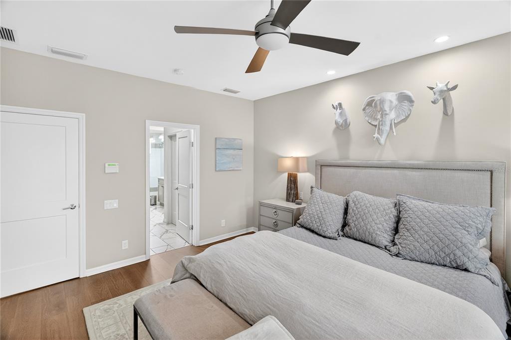 3363 Southwest 115th Terrace Gainesville, FL 32608 - Photo 14 of 43 a bedroom with a bed and wooden floor