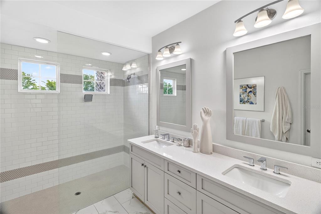 3363 Southwest 115th Terrace Gainesville, FL 32608 - Photo 15 of 43 a bathroom with a tub a sink and mirror