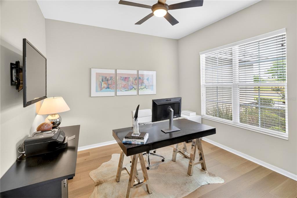 3363 Southwest 115th Terrace Gainesville, FL 32608 - Photo 20 of 43 a view of a workspace with furniture and a window