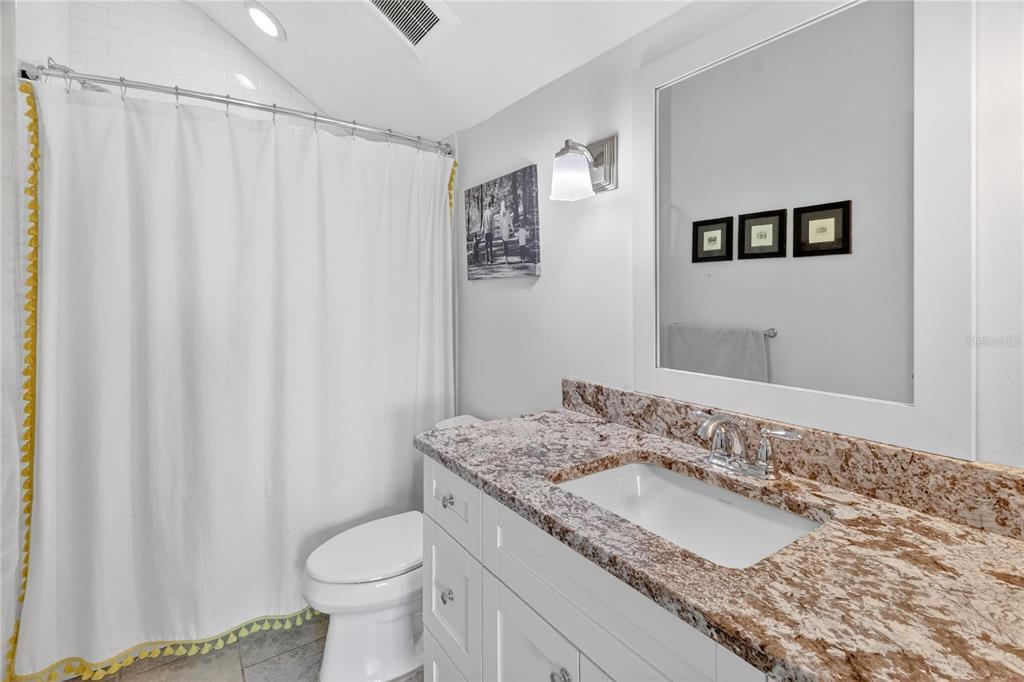 3363 Southwest 115th Terrace Gainesville, FL 32608 - Photo 24 of 43 a bathroom with a granite countertop sink and a mirror