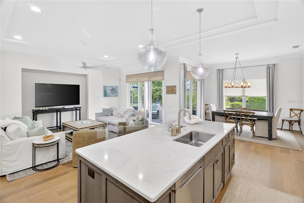 3363 Southwest 115th Terrace Gainesville, FL 32608 - Photo 28 of 43 a living room with furniture a flat screen tv and kitchen view