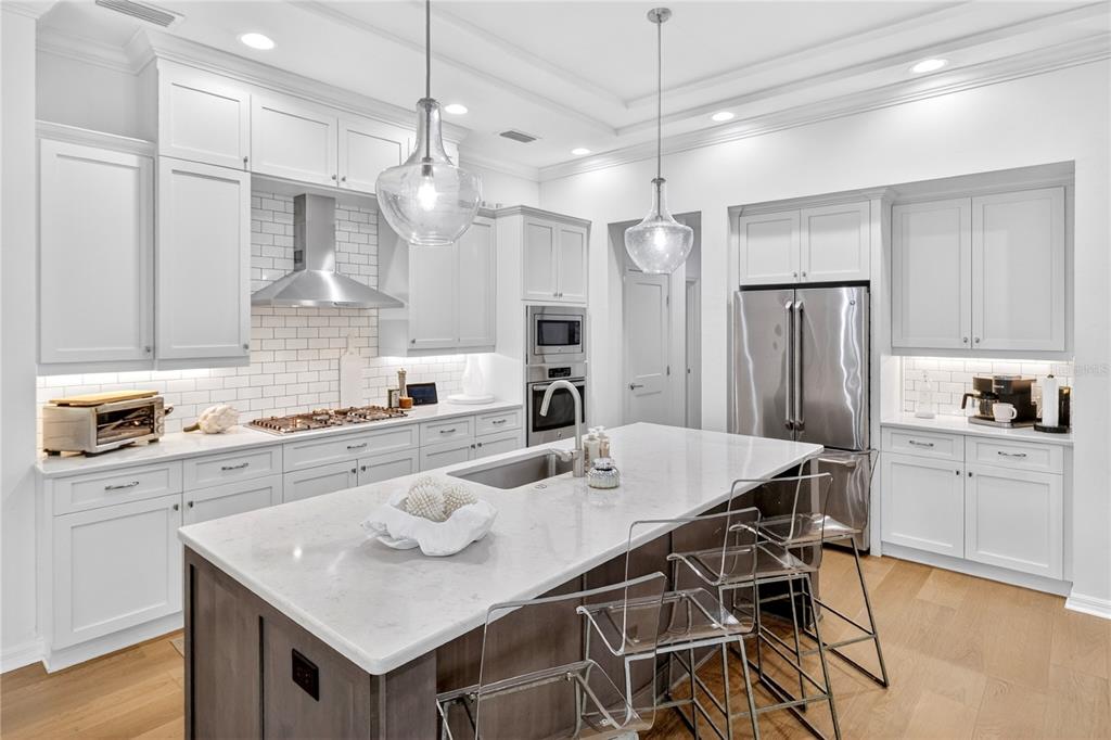 3363 Southwest 115th Terrace Gainesville, FL 32608 - Photo 6 of 43 a kitchen with stainless steel appliances granite countertop a kitchen island a stove a table and chairs in it