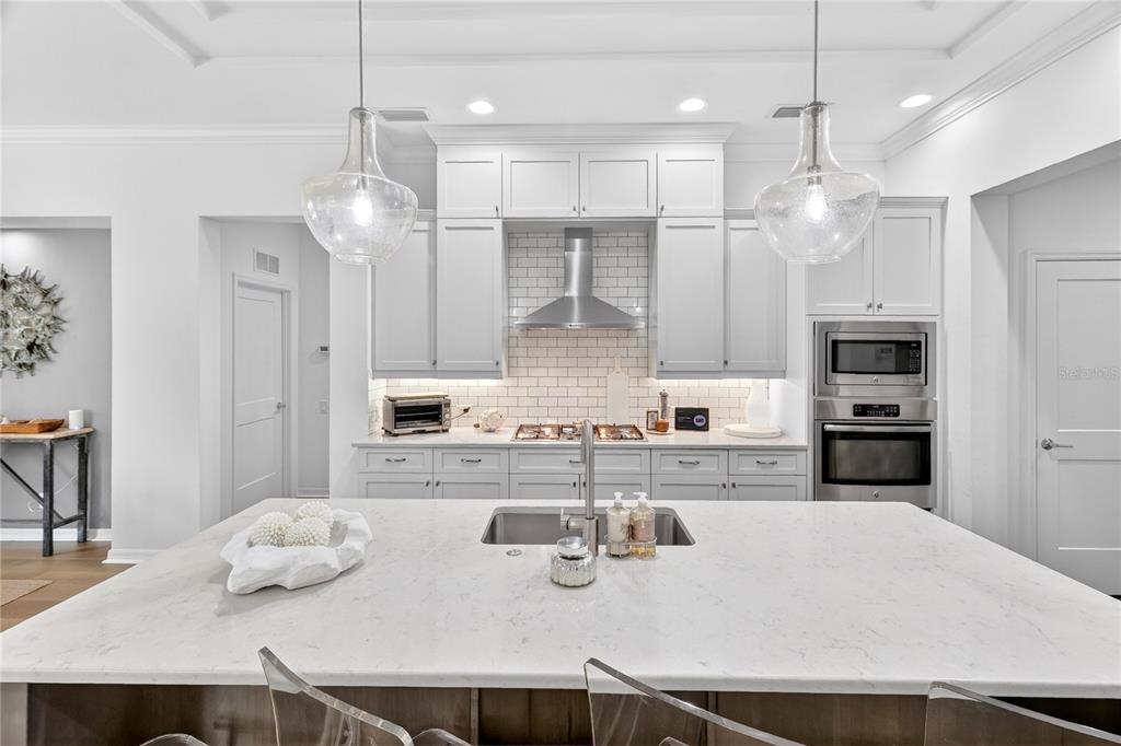 3363 Southwest 115th Terrace Gainesville, FL 32608 - Photo 8 of 43 a kitchen with stainless steel appliances kitchen island granite countertop a sink and refrigerator