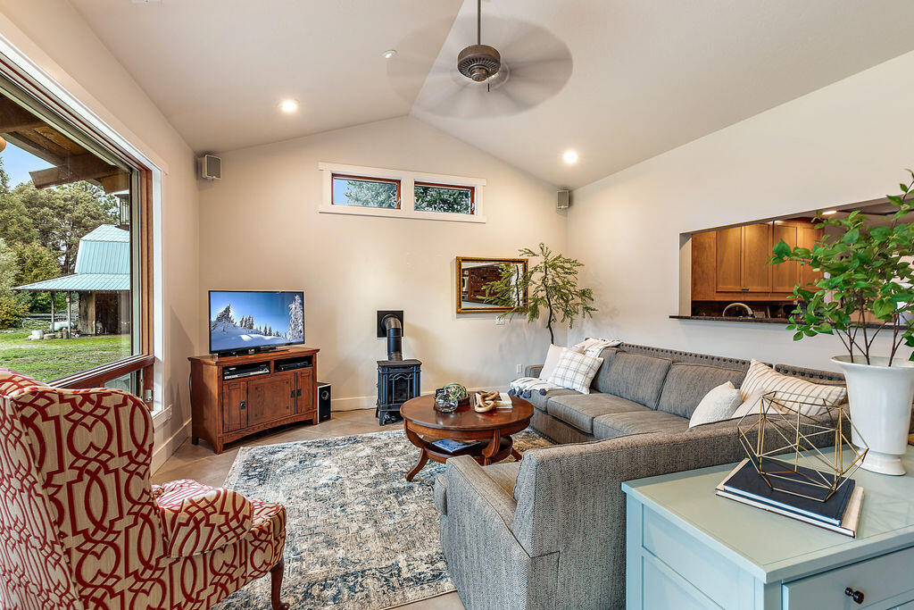 3828 Upper Applegate Road Jacksonville, OR 97530 - Photo 20 of 69 a living room with furniture a flat screen tv and a floor to ceiling window