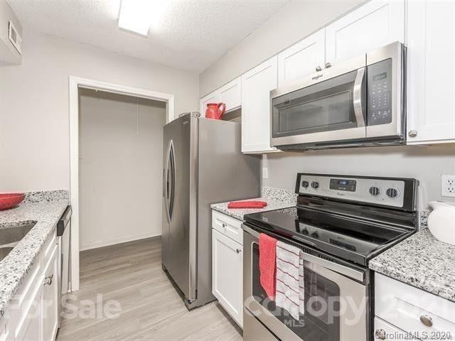 10961 Harrowfield Road Charlotte, NC 28226 - Photo 1 of 13 a kitchen with a stove and a microwave