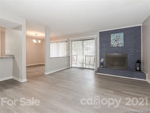 10961 Harrowfield Road Charlotte, NC 28226 - Photo 3 of 13 an empty room with windows and fireplace