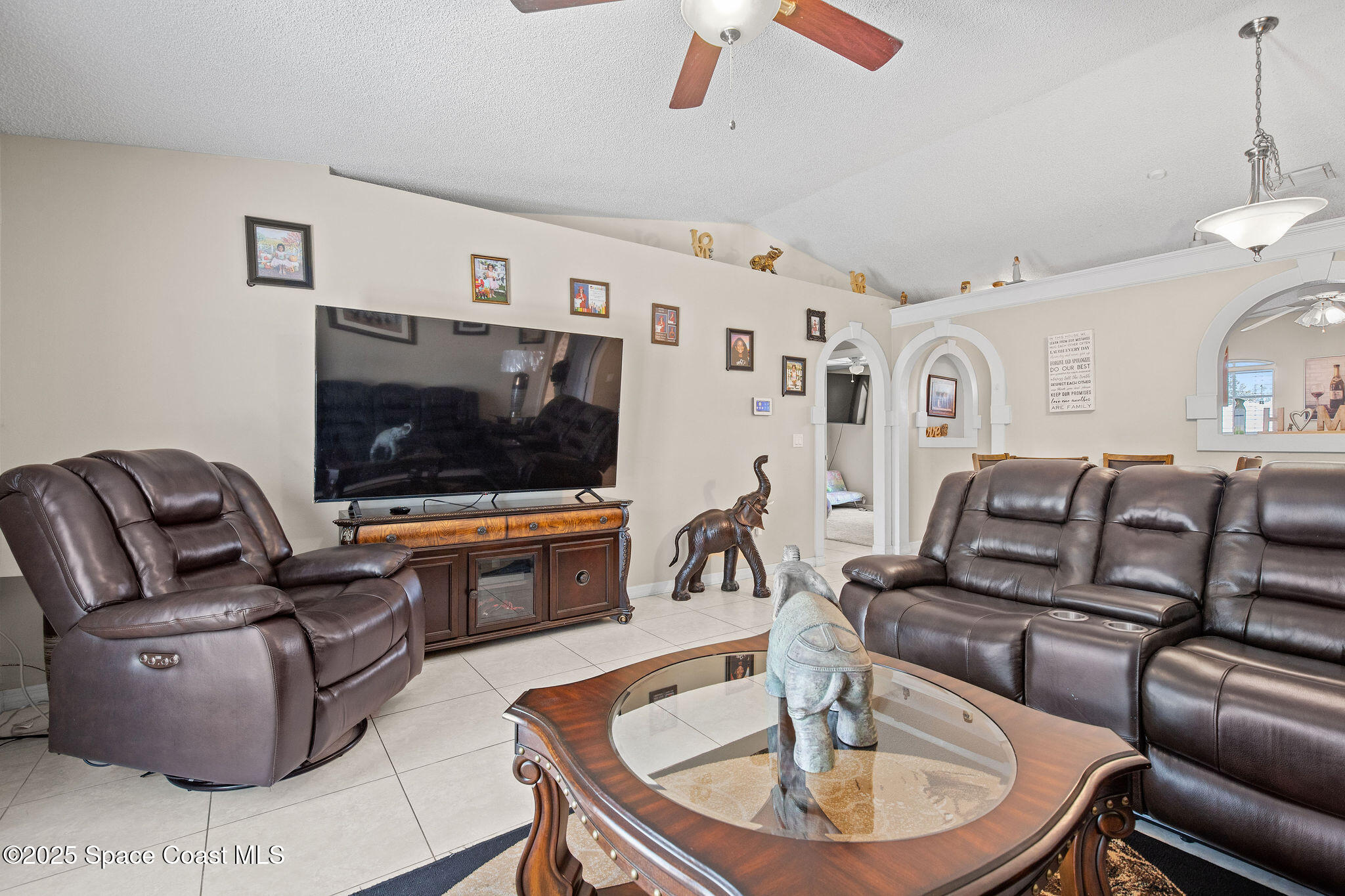 2977 Sebastian Lane Melbourne, FL 32935 - Photo 12 of 26 a living room with furniture and a flat screen tv
