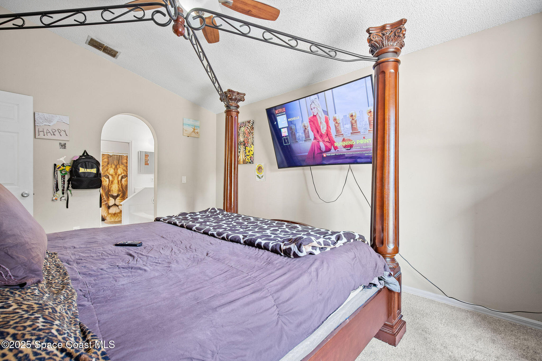 2977 Sebastian Lane Melbourne, FL 32935 - Photo 15 of 26 a bedroom with a bed and a painting on the wall