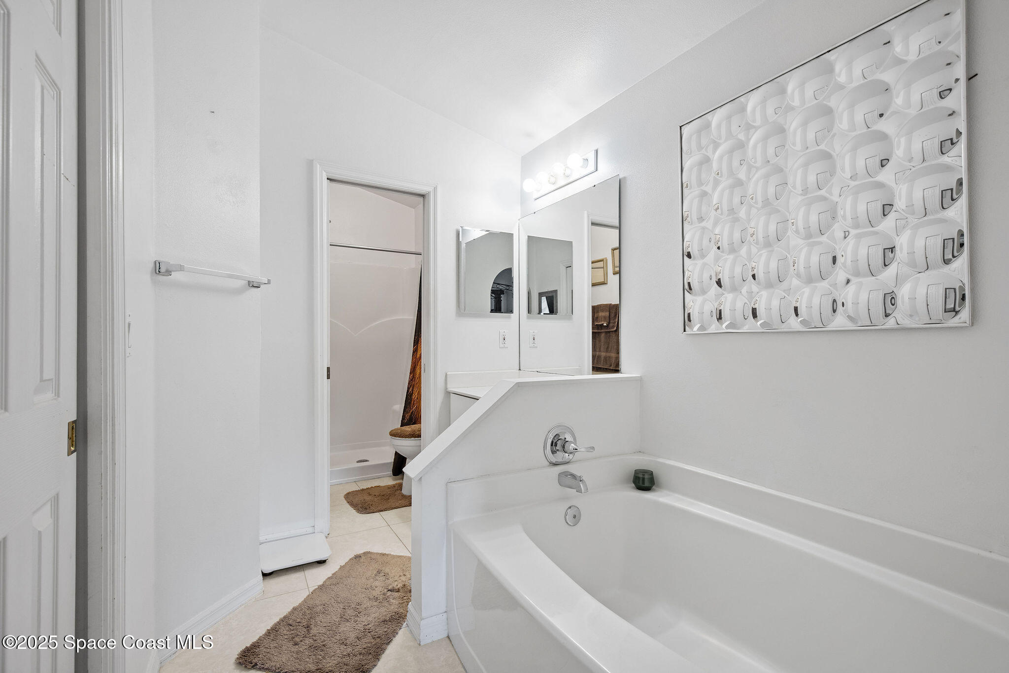 2977 Sebastian Lane Melbourne, FL 32935 - Photo 16 of 26 a bathroom with a bathtub and a shower