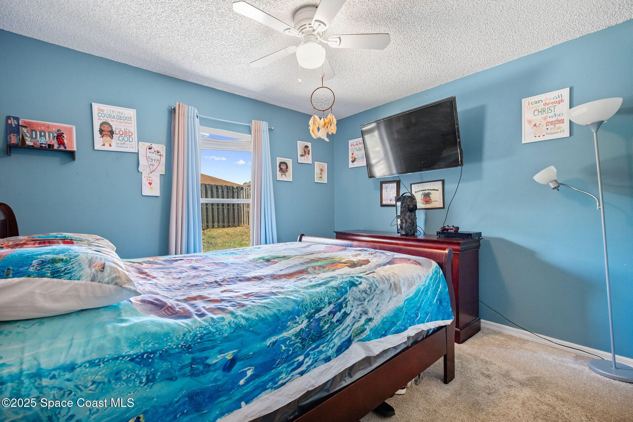 2977 Sebastian Lane Melbourne, FL 32935 - Photo 20 of 26 a bedroom with a bed and a flat screen tv