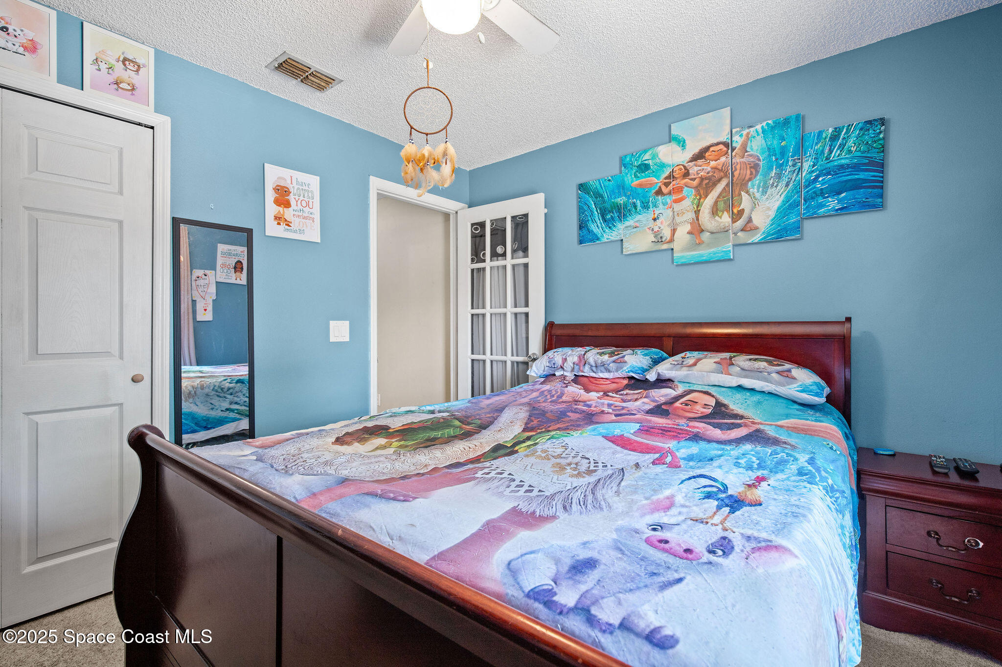 2977 Sebastian Lane Melbourne, FL 32935 - Photo 21 of 26 a bedroom with a bed and painting on the wall