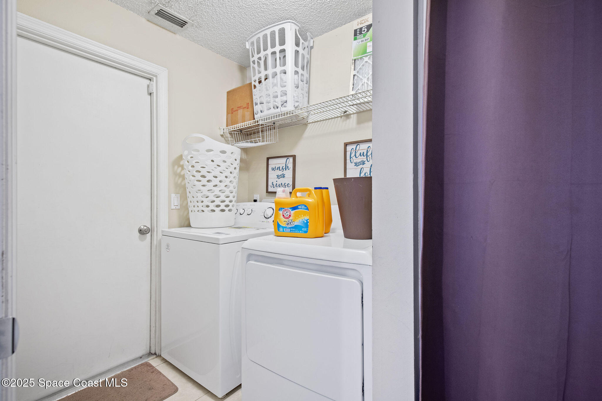 2977 Sebastian Lane Melbourne, FL 32935 - Photo 8 of 26 a utility room with window and washer