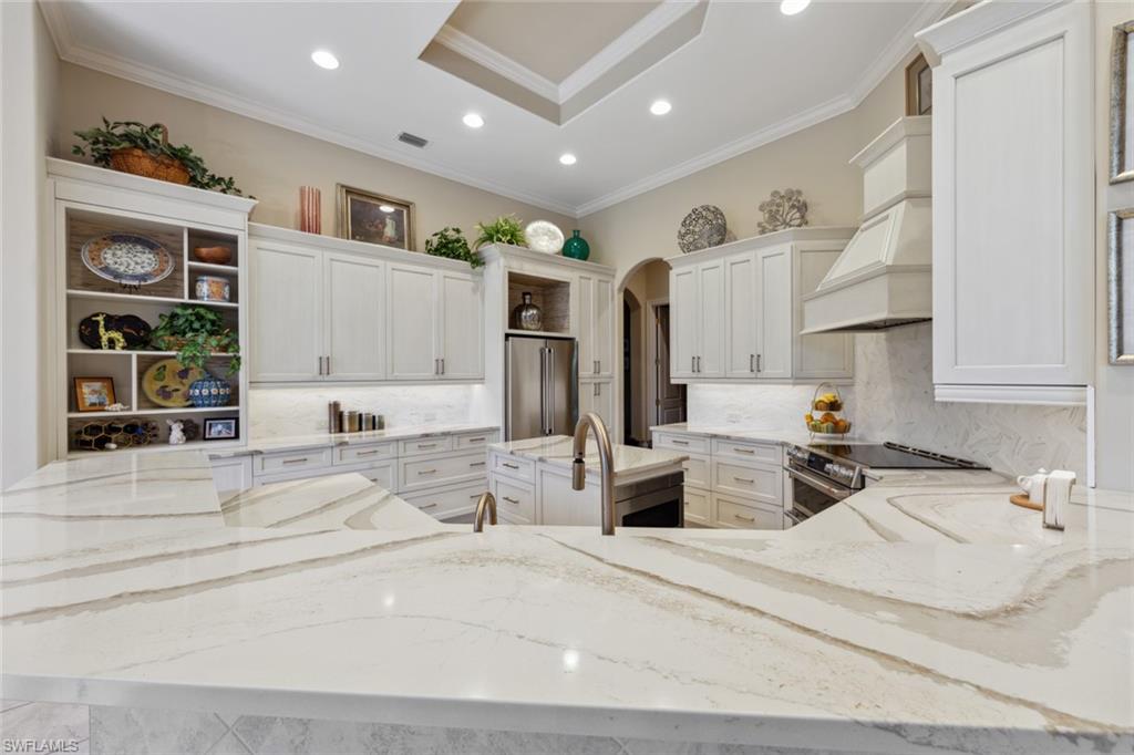 20008 Oak Fairways Court Estero, FL 33928 - Photo 13 of 49 a large bedroom with a large bed cabinets and a window