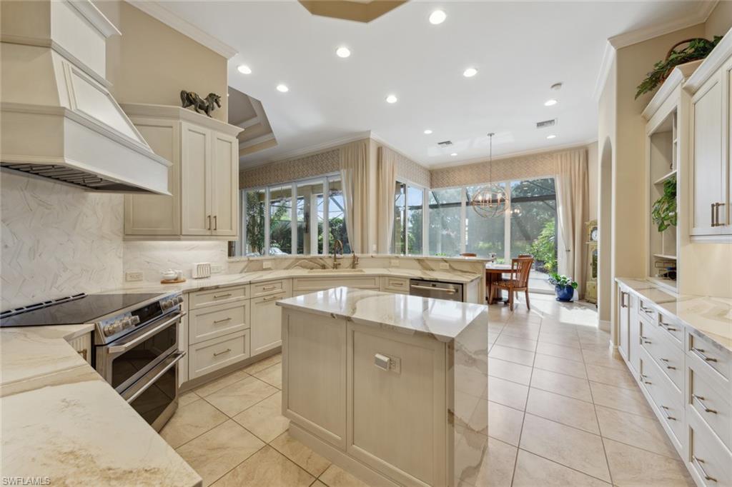 20008 Oak Fairways Court Estero, FL 33928 - Photo 15 of 49 a large kitchen with stainless steel appliances granite countertop a lot of counter space and a sink