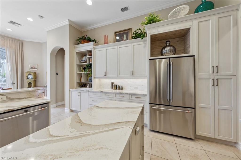 20008 Oak Fairways Court Estero, FL 33928 - Photo 16 of 49 a kitchen with stainless steel appliances a refrigerator sink and cabinets