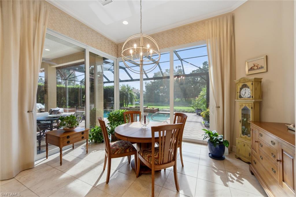 20008 Oak Fairways Court Estero, FL 33928 - Photo 17 of 49 a dining room with furniture a chandelier and wooden floor