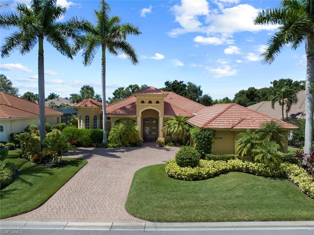 20008 Oak Fairways Court Estero, FL 33928 - Photo 2 of 49 a front view of a house with garden