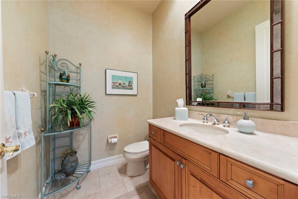 20008 Oak Fairways Court Estero, FL 33928 - Photo 21 of 49 a bathroom with a granite countertop toilet sink and mirror