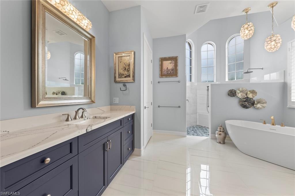 20008 Oak Fairways Court Estero, FL 33928 - Photo 23 of 49 a spacious bathroom with a double vanity sink mirror and bathtub