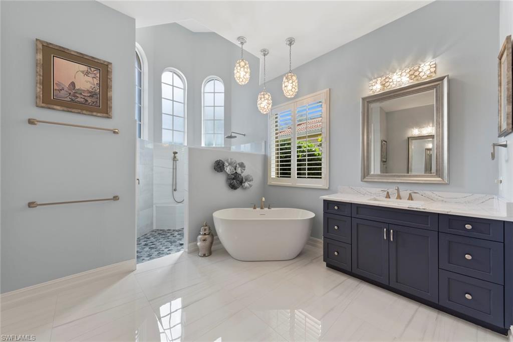 20008 Oak Fairways Court Estero, FL 33928 - Photo 24 of 49 a spacious bathroom with a double vanity sink mirror and bathtub