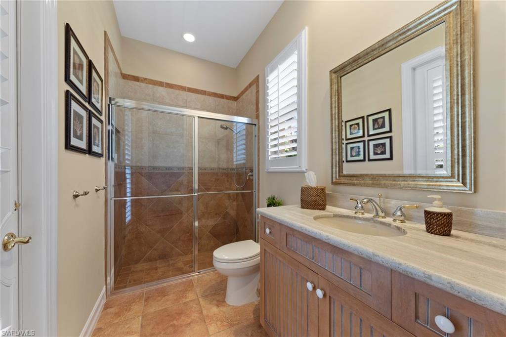20008 Oak Fairways Court Estero, FL 33928 - Photo 27 of 49 a bathroom with a granite countertop sink a toilet and a mirror