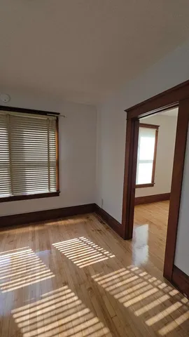 a view of a livingroom with wooden floor and a rug